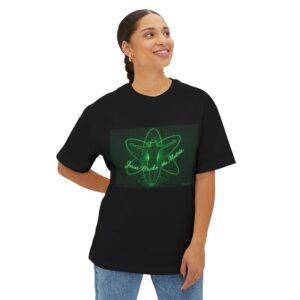 Woman wearing a black t-shirt with a green glowing lotus design.
